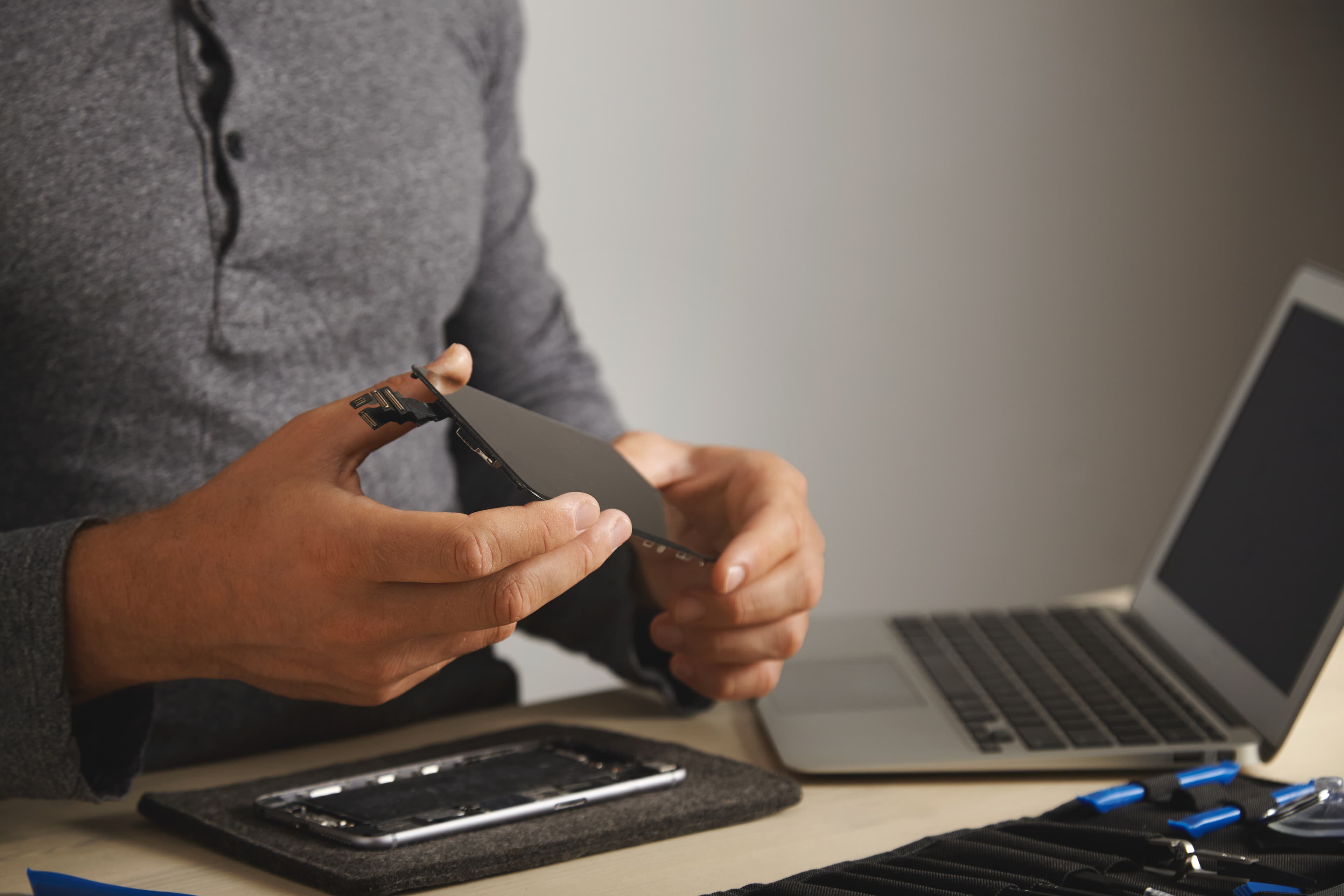 Technician examining a smartphone